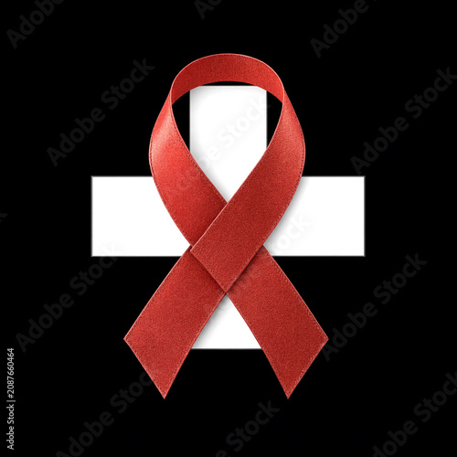 Bright red awareness ribbon beautifully tied in a loop over white cross design