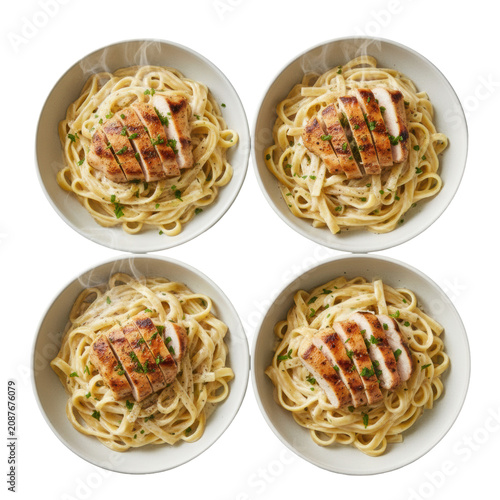 Four ceramic bowls of fettuccine pasta ribbons alfredo with grilled chicken, parsley and nutmeg on a white surface classic gourmet italian cuisine concept