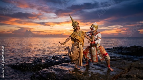 Thai Khon Dancers Posing on a Rocky Ocean Beach at Sunset