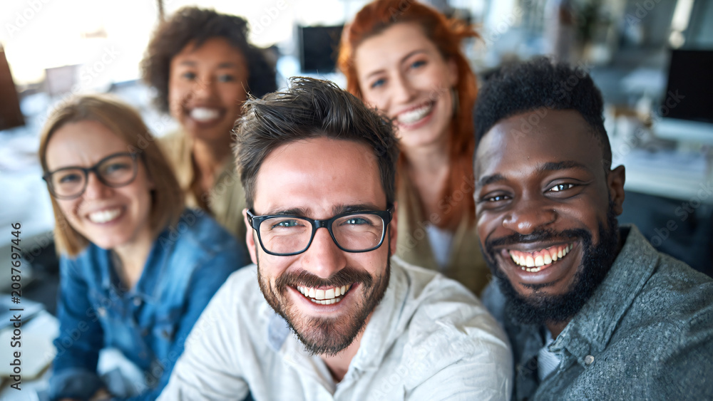 Fototapeta premium Happy Diverse Group of People Smiling Together in Modern Office, Teamwork and Success Concept with Business Professionals, Friends and Colleagues Building Strong Collaboration.