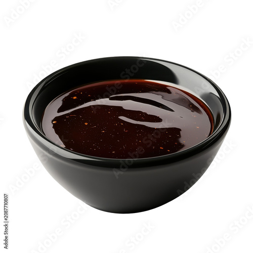 Glossy dark sauce in a small black bowl isolated on white background