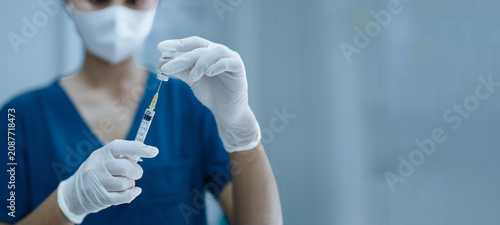 Obraz na płótnie Nurse Preparing Vaccine Injection from Medical Vial Using Sterile Syringe