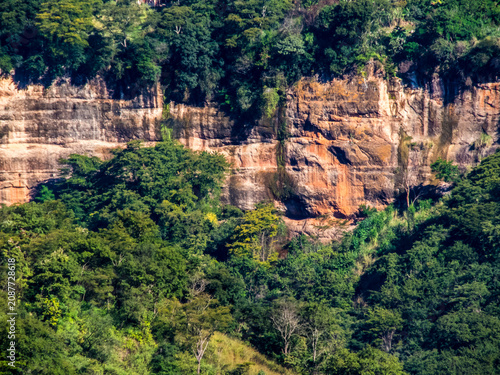 Panoramic view of a massive geological sandstone formation surrounded by lush tropical green foliage at the Itambe valley in Marilia, Sao Paulo, Brazil. 