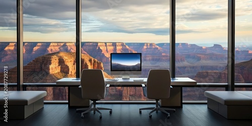 Office workspace with dual chairs overlooking a vast canyon landscape.