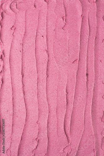 Top view of pink buttercream for decorating cake, textured american buttercream with patterns, overhead view of grainy pink buttercream, cream textured background
