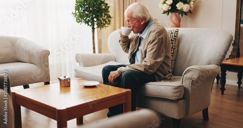 Canvastavla Senior, man and drinking tea in nursing home with thinking, peaceful moment or daydream of past history