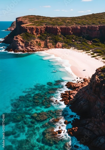 A secluded white sand beach nestled beneath towering red cliffs with vibrant turquoise ocean waters and a small boat anchored in the clear bay