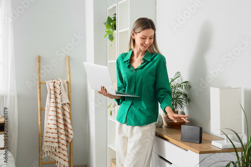 Young woman using smart spe...