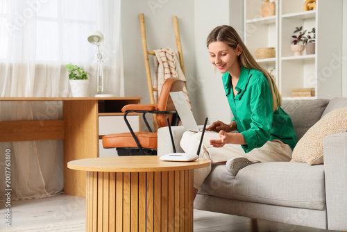 Young woman using laptop an...