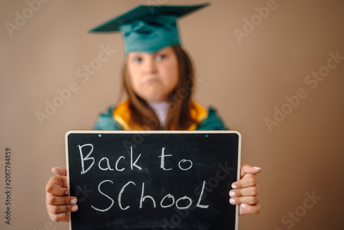 Konstfotografi Child holding back to school sign feeling reluctant