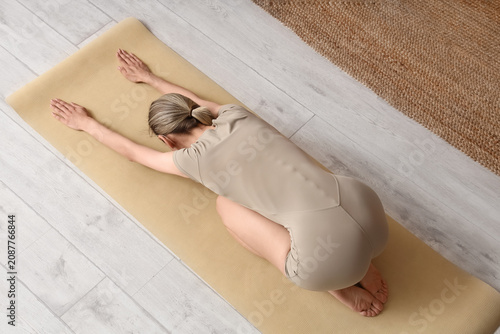 Woman practicing yoga child...