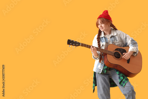 Redhead teenage girl playin...