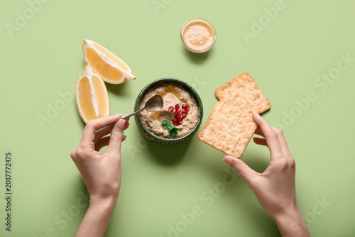 Young woman eating tasty ba...