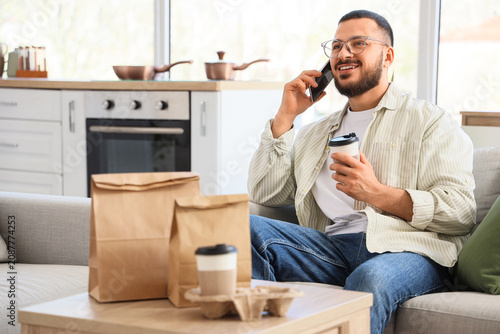 Young man with coffee cup a...