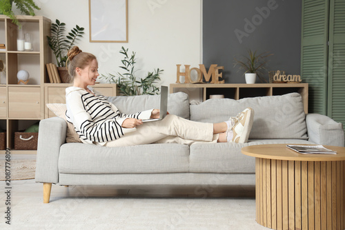 Young woman using modern la...