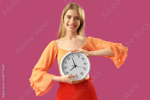 Young woman with clock on p...