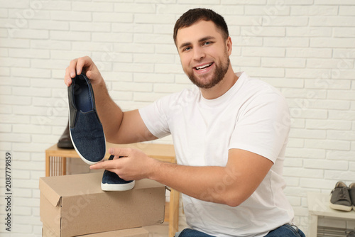 Happy young man with shoes ...