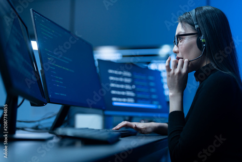 Customer service, asian female IT support engineer wearing headset working on computer code, technical helpdesk, call center, software development, cybersecurity and global corporate communications