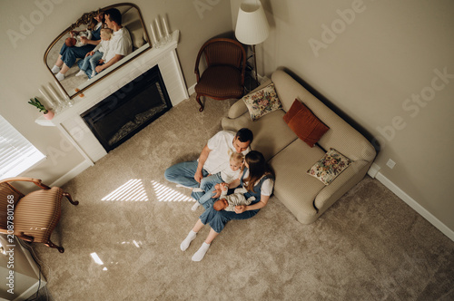 Top view of a happy family with two children in a cozy living room.