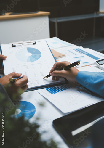 Auditor and accountant team working in office, analyze financial data and accounting record with calculator. Accounting company provide finance and taxation planning for profitable cash flow.