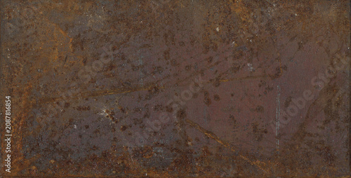 Billede på lærred Rusty rectangular metal plate featuring heavy oxidized patches and coarse weathered iron surface with dark brown corrosion details