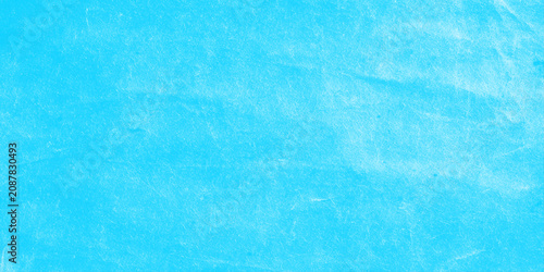 bright blue watercolor texture background with soft scratched, distressed brush strokes and a subtle vignetted texture.