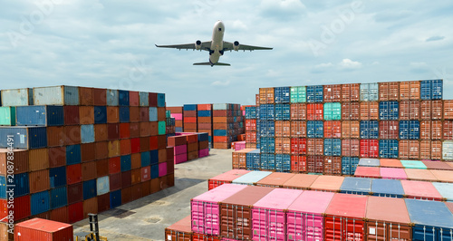 Vászonkép Airplane flying above container logistic