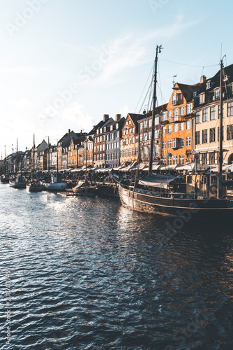 sunset light at nyhavn canal in copenhagen and boats foreground