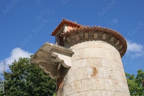 Fotografie Traditional stone tower structure with a tiled roof