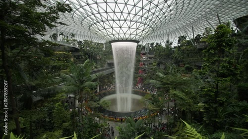Spectacular interior of Changi Airport in Singapore featuring futuristic bionic architecture tropical greenery and a breathtaking indoor waterfall in Asia