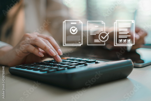Hand using calculator with virtual approved document checklist and quality control icons