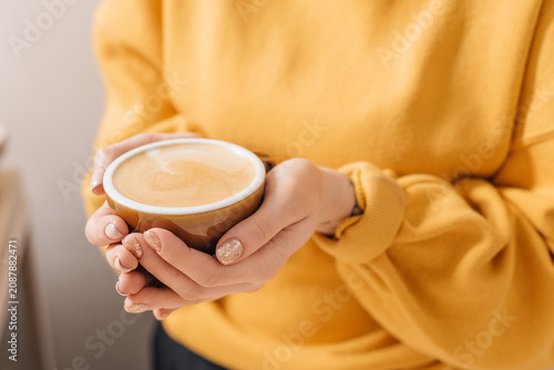 Barista holding a cup with coffee drink ready