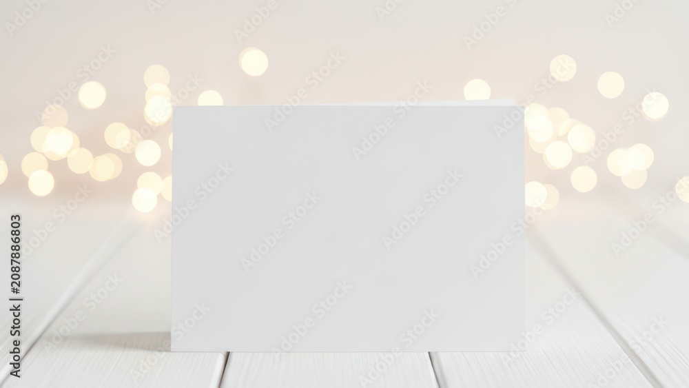Fototapeta premium Blank White Greeting Card on Bokeh Background