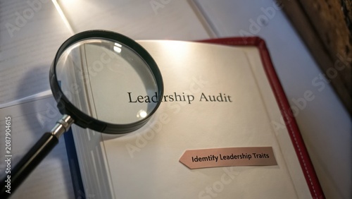 Leadership Audit Analysis with Magnifying Glass Highlighting Identity Leadership Traits in Business Context