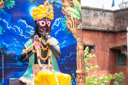 Obraz na plátně Lord Krishna Statue Playing Flute in Traditional Hindu Temple Decoration