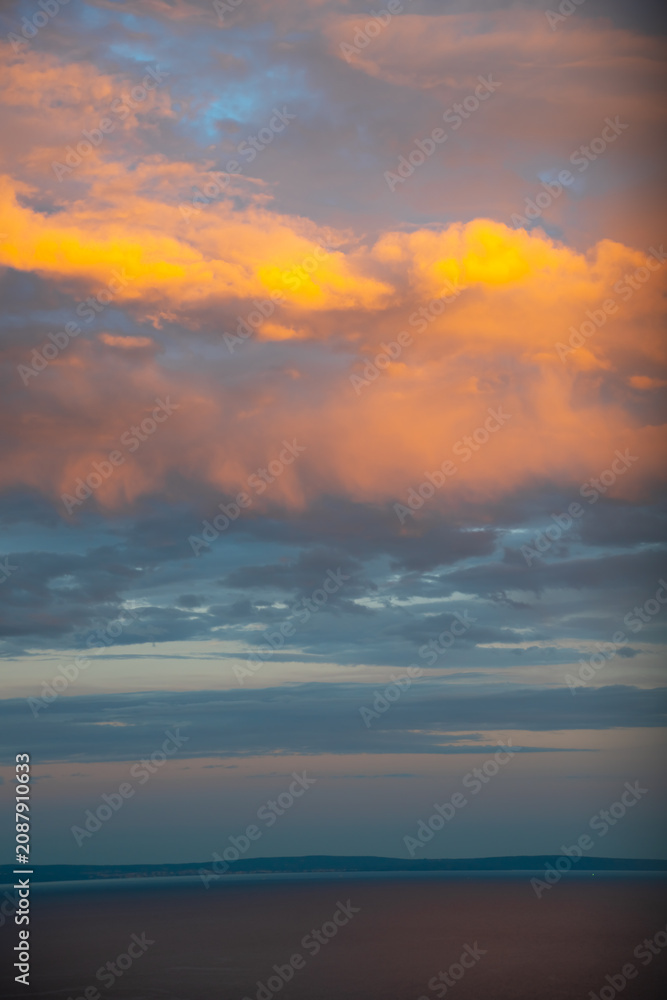 Fototapeta premium Golden sunset clouds after storm over the Adriatic Sea with peaceful horizon