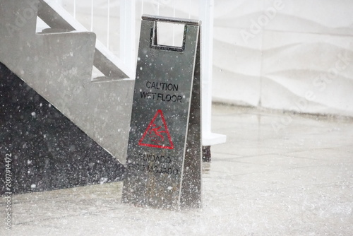 Obraz na płótnie Outside wet floor sign in heavy downpour