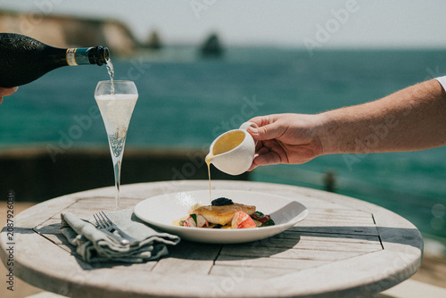 Canvas Print Elegant seaside dining experience with champagne and gourmet food