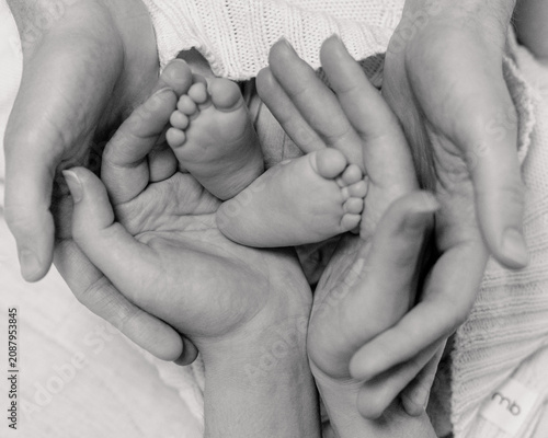 Monochrome infant feet family background