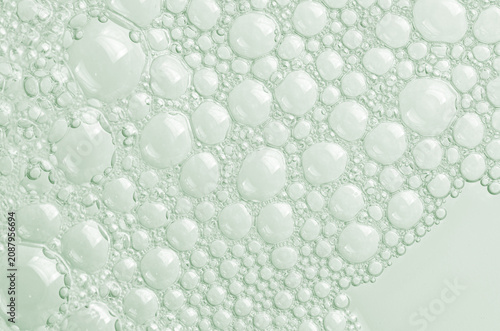 Bubbles of body gel or soap foam or shaving gel. Closeup.