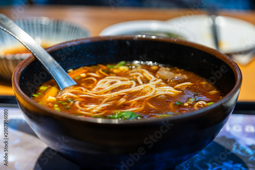 A close-up of classic traditional beef noodle soup and its rich broth.