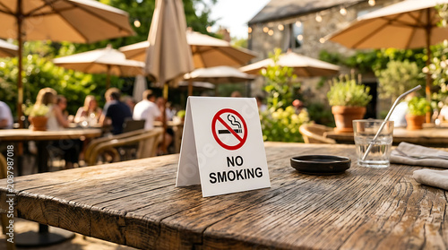 No smoking sign on a wooden table at an outdoor restaurant terrace cafe