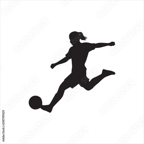 Silhouette of a female soccer player striking the ball with power during a match.