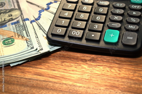 United States dollar banknotes calculator on wooden table Copy space Money management concept Financial planning Cash savings Investment strategy Payment calculation Business expenses Income analysis
