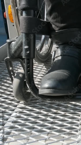 Wheelchair User Utilizing Accessible Lift to Enter Passenger Van