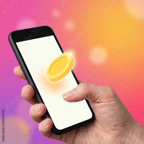 Hand holding smartphone with floating gold coin icon against vibrant bokeh, representing digital finance and mobile payment success.