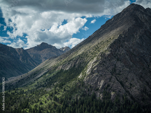 Aerial View of Light and Shadow over Mount Genyen Glacial Valley and Forest