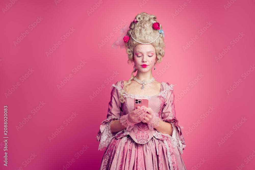 Fototapeta premium Photo of gorgeous pretty lady dressed pompous rococo costume chatting modern device empty space isolated pink color background