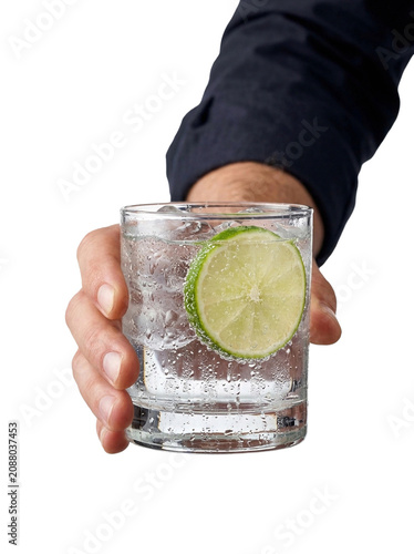 Hand holding a gin and tonic with lime, transparent background