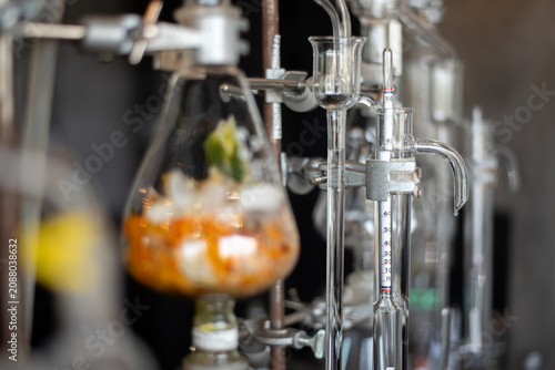 Bild auf Leinwand Close-up of a hydrometer inside a glass tube connected to a distillation apparatus in a laboratory setup